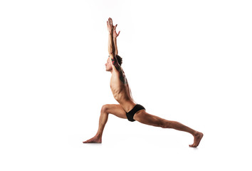 Fototapeta premium yoga and gymnastics, posture hero, lunge on the leg with his hands up