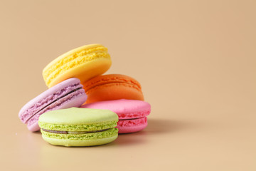 colorful macaroons on beige background