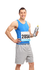 Male runner athlete holding a water bottle