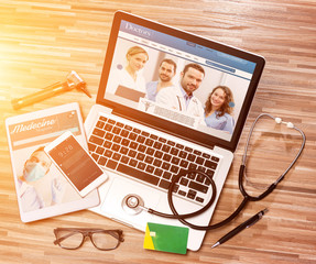 Wood doctor's desk in high definition with laptop, tablet and mo