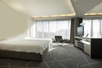 Interior of a double hotel bedroom in the morning, sunlight