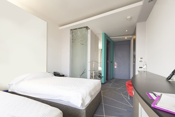 Interior of a double hotel bedroom in the morning sunlight