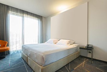 Interior of a double hotel bedroom in the morning, sunlight