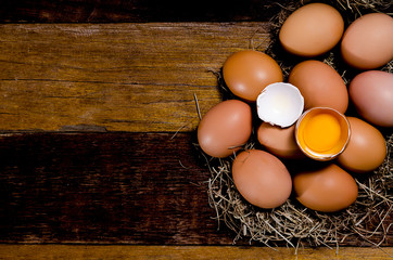 Eggs in nest on dark vintage wooden background.Top view