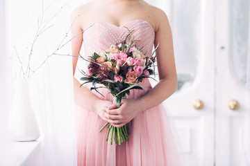bridal bouquet from pink roses in hands