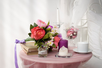 a bouquet of flowers on the bedside table