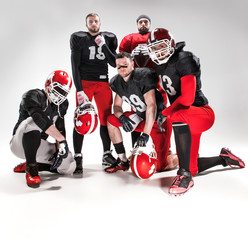 Fototapeta na wymiar The five american football players posing with ball on white background