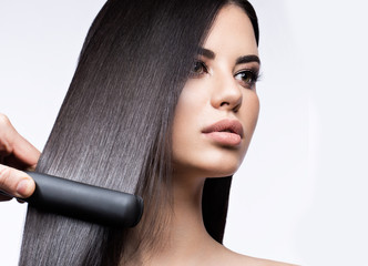 Beautiful brunette girl with a perfectly smooth hair, curling and classic make-up. Beauty face. 