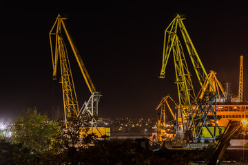 Burgas, Bulgaria - August 26, 2015    21:29h : Cargo cranes on the coast of Fish port of Burgas, Bulgaria