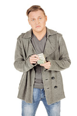 angry young man holding Money Cash Dollars in hands. Negative human expression