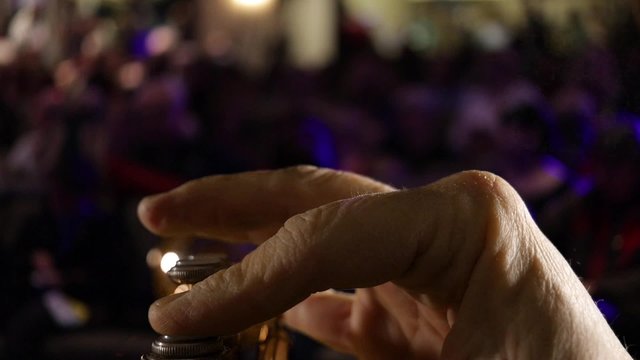 Musician POV of trumpet player performing before crowd