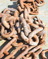 old, rusty chain on a boat deck. Industrial equipment or nautical vessel.