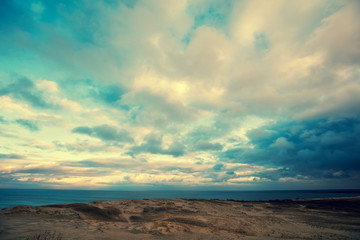 Fototapeta na wymiar Sea shore with cloudy blue sky