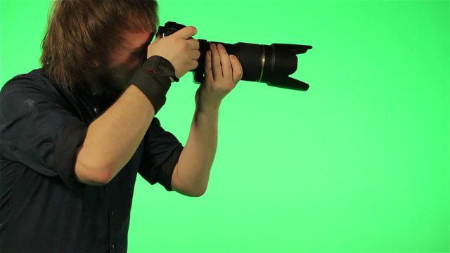 photographer takes pictures on a green screen