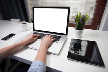 woman working on laptop on wooden desk in office