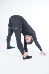 Young male performing yoga