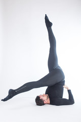 Young male performing yoga