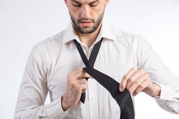 Man ties a necktie knot