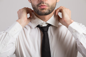 Man ties a necktie knot