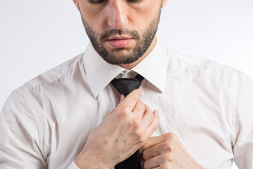 Man ties a necktie knot