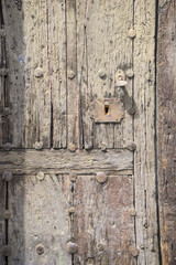Old wooden door with brass padlock