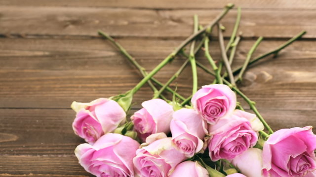 Pink roses on rustic wood table