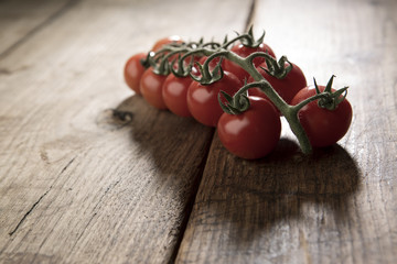 controluce di pomodori a grappolo isolati su sfondo legno