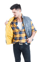 Attractive male model wearing plaid shirt and holding his vest