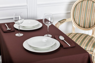 Beautiful decorated table with linen napkins, cutlery on luxurious tablecloth