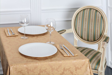 Beautiful decorated table with linen napkins, cutlery on luxurious tablecloth