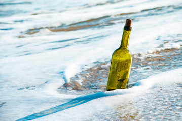 Message in a bottle on the beach seashore.