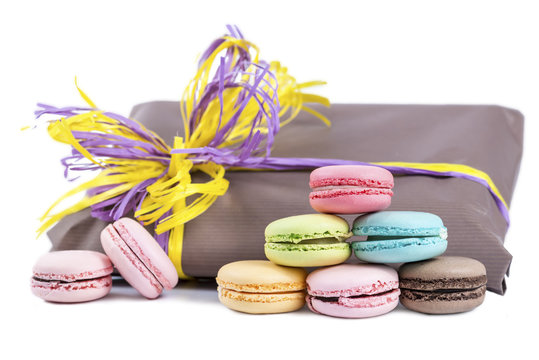 macaroon pyramid on a background of gift packages isolated on wh