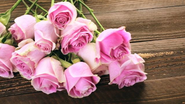 Pink roses on rustic wood table