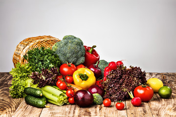 The vegetables from a  basket on wooden table