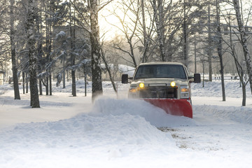 Snow plow doing snow removal after a blizzard