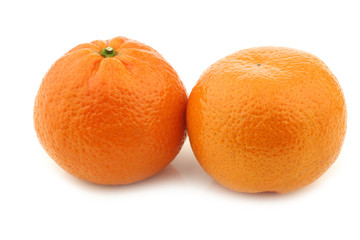 two fresh tangerines on a white background
