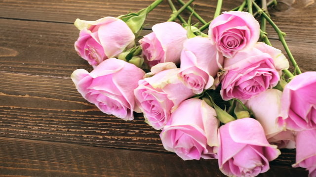 Pink roses on rustic wood table
