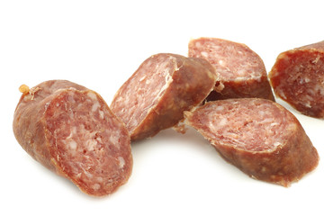 cut pieces of traditional frisian smoked and dried sausages on a white background
