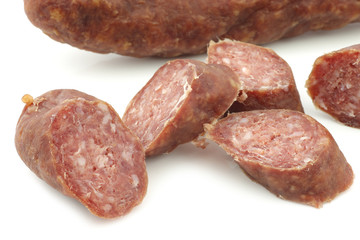 cut pieces of traditional frisian smoked and dried sausages on a white background
