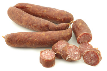 cut pieces of traditional frisian smoked and dried sausages on a white background
