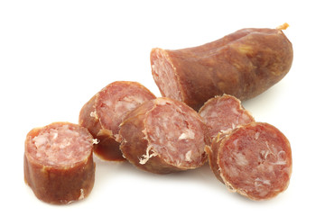 Obraz premium cut pieces of traditional frisian smoked and dried sausages on a white background 