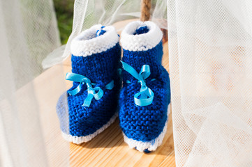 The wreath of flowers and booties