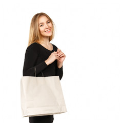 Young woman in a black dress with shopping bags, isolated on a w