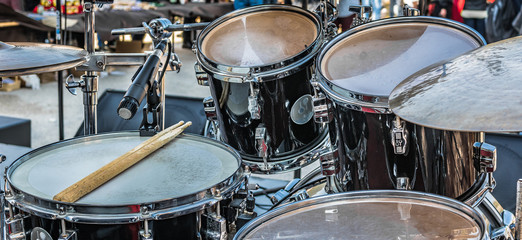 Fototapeta na wymiar Drums few minutes before concert starts. / Photography is taken on small local stage before rock concert in Ston, Croatia.