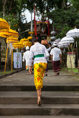 Woman walks up the stairs during the celebration before Nyepi (Balinese Day of Silence). Ubud, Indonesia.
