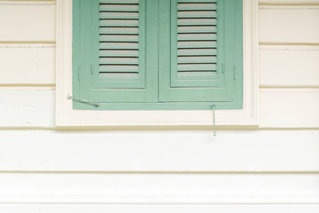 the wooden vintage green windows on the classic house