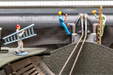 Team of workers performing maintenance activity with ladder and working tools