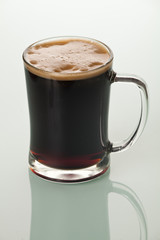 Full glass of beer or kvass on a glass table