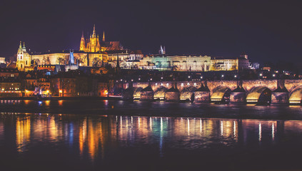 Fototapeta premium Castle, Charles Bridge and Vltava river, Night panorama of Prague, Czech Republic, vintage effect