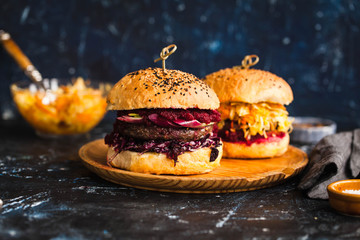 Homemade hamburger with grilling beef and red cabbage salad.